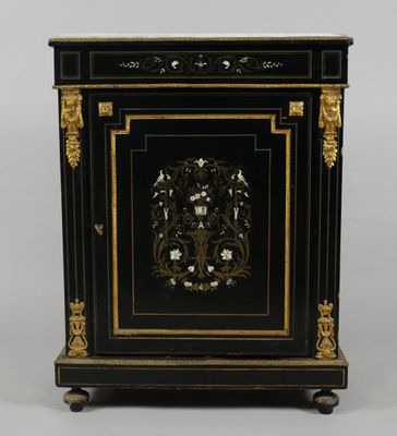 a black and gold painted cabinet with a floral design on the door