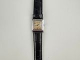 a close up of a wrist watch on a white surface