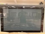 a large flat screen tv sitting on a stand in a living room