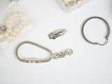 a white table with a bunch of jewelry on it