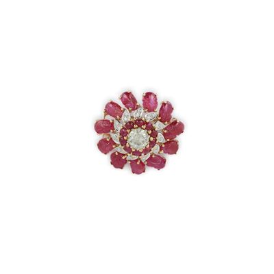 un gros plan sur une broche en forme de fleur en diamants rouges et blancs