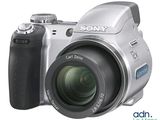 a silver digital camera that is sitting on a white surface
