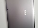the back of a silver laptop with a sticker on it
