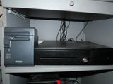 a computer and a printer on a shelf in a room