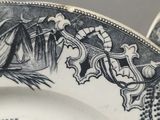 someone is holding a plate with a drawing of a horse and carriage on it