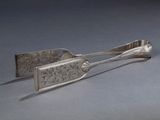 une cuillère en argent et une cuillère à manche posées sur une table