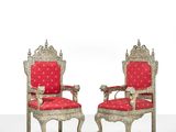 pair of silver and red chairs with red upholstered cushions
