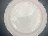 a white plate that has a picture of a woman on it