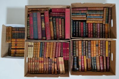 boxes of old books are stacked on top of each other on a table