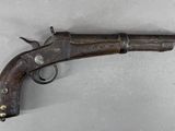 gros plan d'un pistolet sur une table à fond blanc