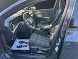 the interior of a car with the door open and the driver ' s seat up
