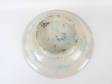 a white plate with a blue and brown design on it