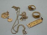a lot of gold jewelry on a white table