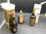 three bottles of alcohol sitting next to each other on a counter
