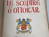 an open book with a coat of arms on it