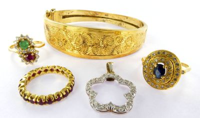an assortment of gold jewelry including rings, bracelets, and rings