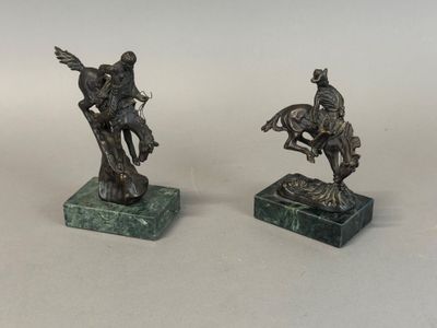two bronze statues of a man on a horse and a man on a horse