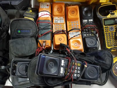 many cell phones and other electronic equipment on the table