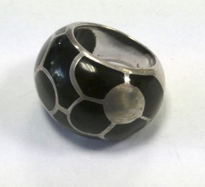 a black and silver ring with a white dot on it