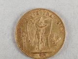 a close up of a gold coin on a white surface