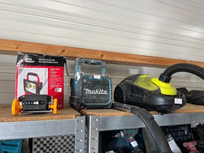 many different tools on a shelf in a garage
