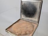 a small silver box with a mirror on top of it