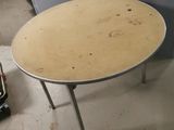 a small round table with a metal base in a room
