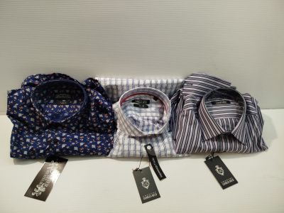 three men ' s shirts on a table with tags on them