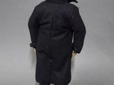 a close up of a toy figure of a man in a black coat