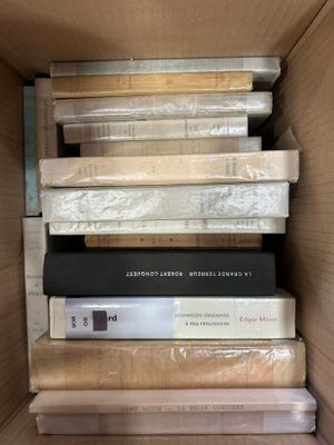 a lot of books stacked on top of each other in a box