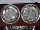 two silver plates in a wooden box with a white cloth
