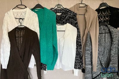 a lot of clothes hanging on a rack in a room