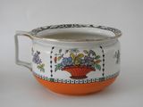 an orange and white bowl with a flower design on it