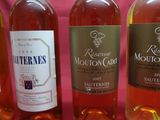 several bottles of wine are lined up on a table