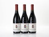 three bottles of wine sitting on top of a white table