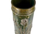 a green vase with flowers on it on a white background