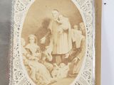an old picture of a woman and children in a picture frame