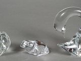 three glass animals sitting next to each other on a table