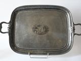 an antique silver plate with handles and handles on a stand