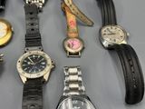 a lot of watches that are sitting on a table