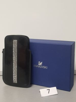the black purse is next to a blue box with a name tag