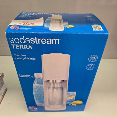 a box of sodastream on a table next to a box of soda