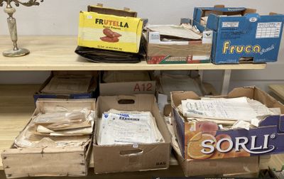 several boxes of food are stacked on a shelf in a room