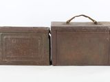 pair of antique metal boxes with handles on white background