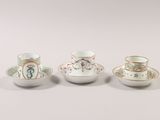 three small cups and saucers sitting next to each other on a table