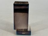 a small metal object that is on a white surface
