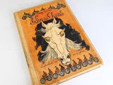 un vieux livre dont la couverture est ornée d'une image de cheval