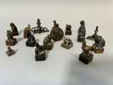 de nombreuses figurines en bronze posées sur une surface blanche