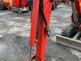 a red excavator that is sitting in the dirt
