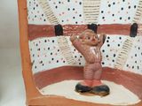 a clay figurine of a man in a circus ring